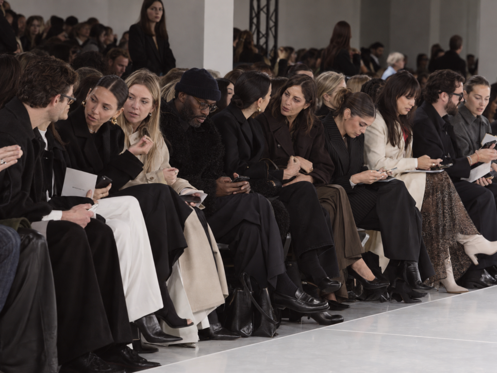 Des journalistes, clients, influenceurs attendent le début d'un défilé de la Paris Fashion Week.