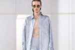 Silhouette Carven printemps-été 2027 à la Paris Fashion Week, avec chemise bleu clair oversize, pantalon transparent et lunettes de soleil.