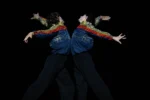 Hugo Marchand et Germain Louvet dans Rings of Saturn, bras courbés et costumes Chanel colorés sur scène.